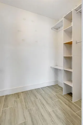 a view of walk in closet with empty racks