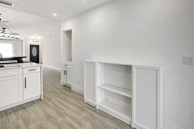 a kitchen with a refrigerator and a stove top oven