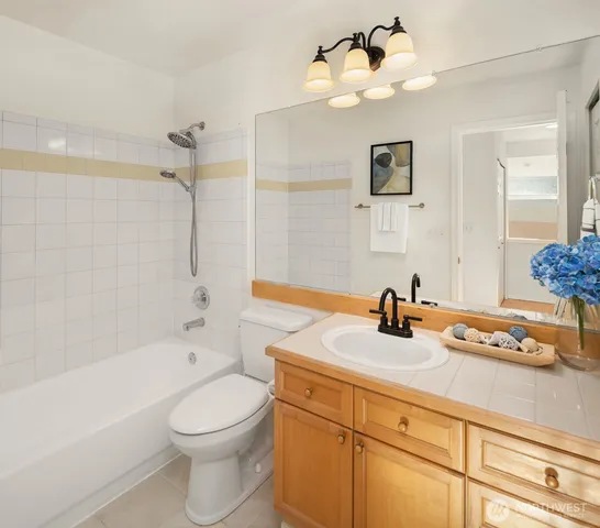 a bathroom with a sink a mirror and a toilet