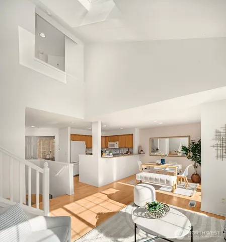 a living room with furniture and view of kitchen