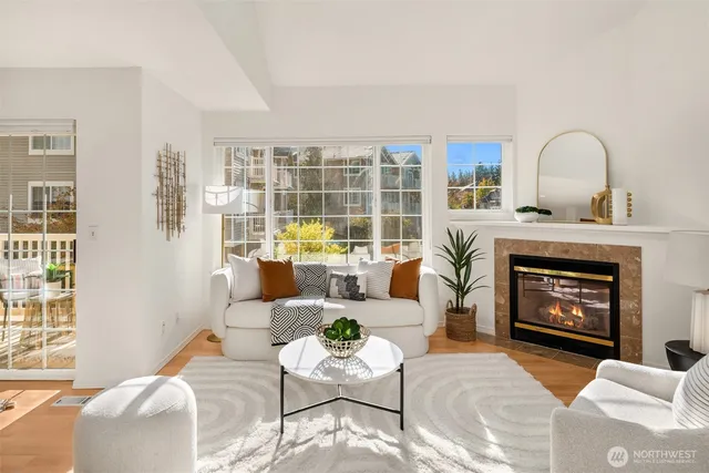 a living room with furniture a fireplace and window