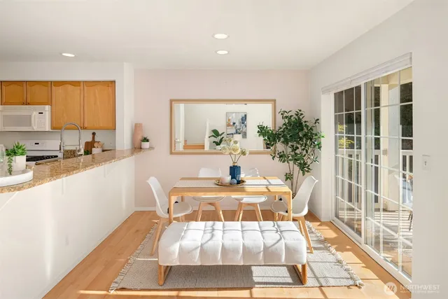 a dining room with a table and chairs next to a window