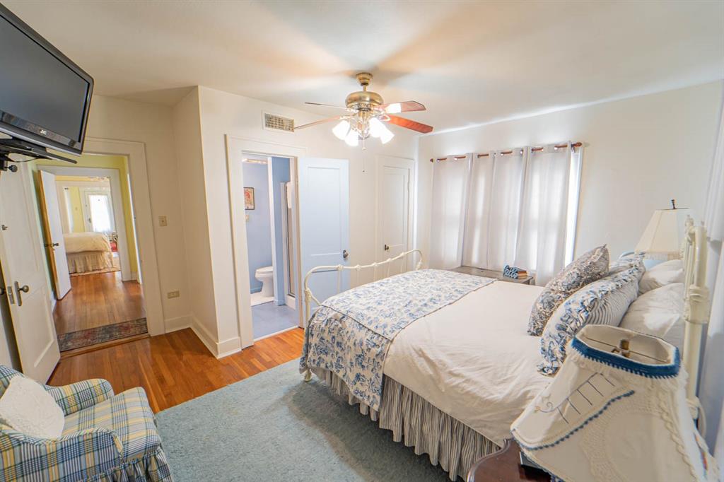 900 West Walker Street Breckenridge, TX 76424 - Photo 16 of 40 a bedroom with a bed and a chandelier