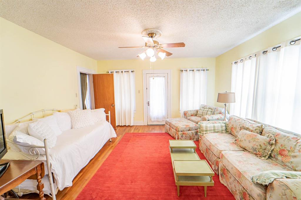 900 West Walker Street Breckenridge, TX 76424 - Photo 21 of 40 a bed room with a bed and a chandelier