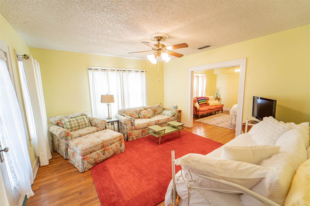 900 West Walker Street Breckenridge, TX 76424 - Photo 22 of 40 a bedroom with furniture and a large window