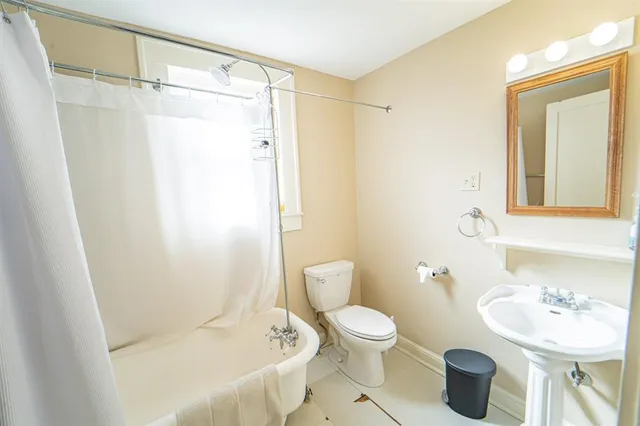 a white toilet sitting next to a bathroom sink