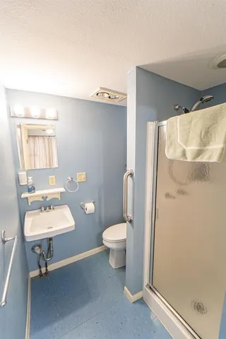 a bathroom with a toilet and a shower