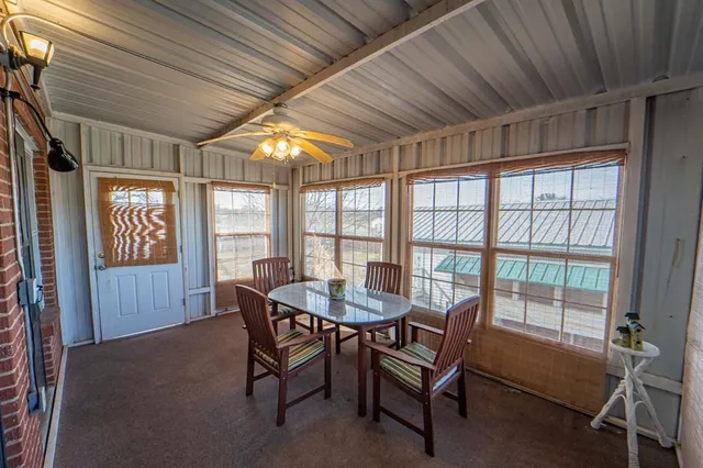 a dining room with furniture and window
