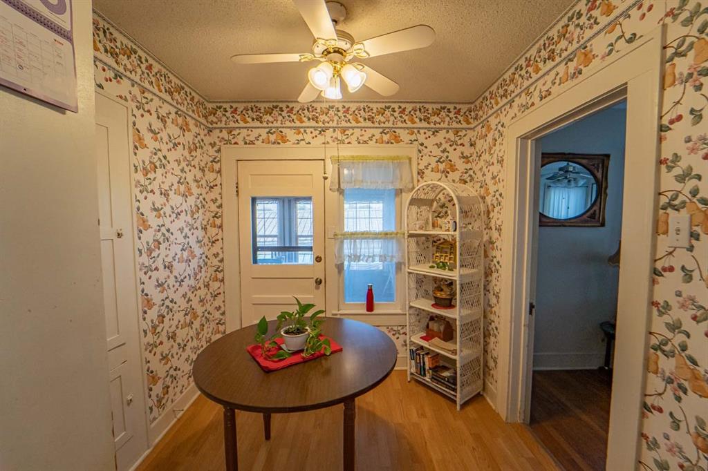 900 West Walker Street Breckenridge, TX 76424 - Photo 6 of 40 a view of a dining room with furniture and wooden floor