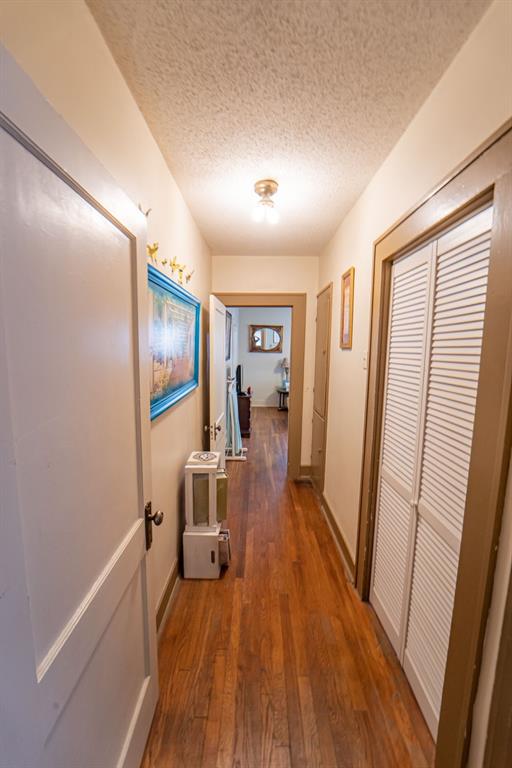 900 West Walker Street Breckenridge, TX 76424 - Photo 10 of 40 a view of a hallway with a livingroom and furniture