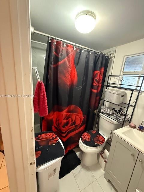 276 East 12th Street Hialeah, FL 33010 - Photo 19 of 25 a bathroom with a toilet and a shower curtain