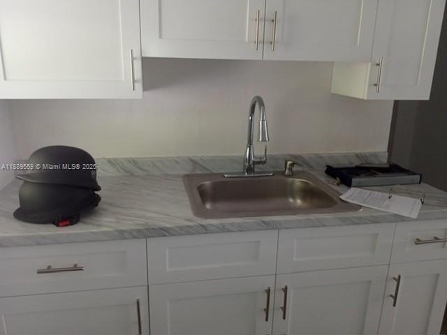 276 East 12th Street Hialeah, FL 33010 - Photo 21 of 25 a kitchen with a sink and cabinets