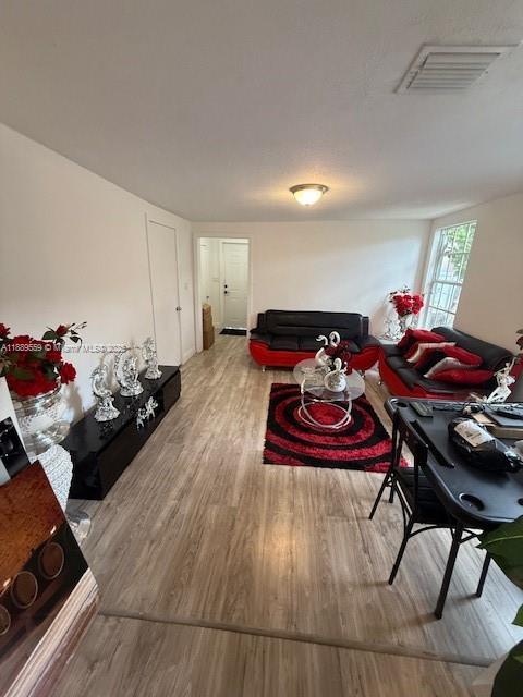 276 East 12th Street Hialeah, FL 33010 - Photo 9 of 25 a living room with furniture and wooden floor