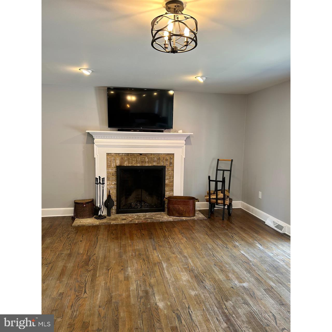 106 Hammersmith Lane Lititz, PA 17543 - Photo 27 of 28 a view of an empty room with a fireplace and a flat screen tv
