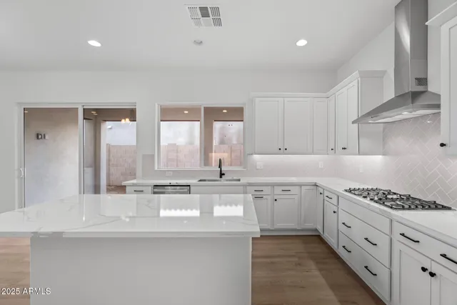 a kitchen with stainless steel appliances granite countertop a stove and a sink