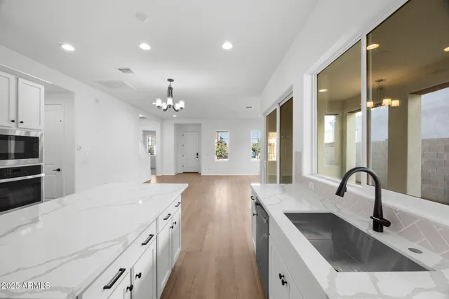 a kitchen with a sink stove and cabinets
