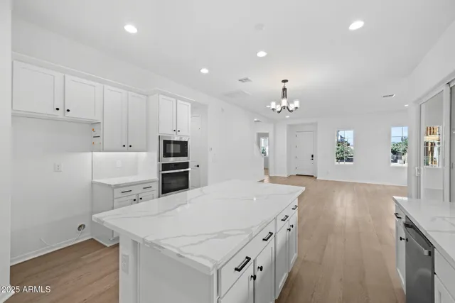 a kitchen with kitchen island a sink stainless steel appliances and cabinets