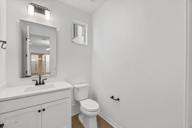 a bathroom with a sink toilet and a mirror