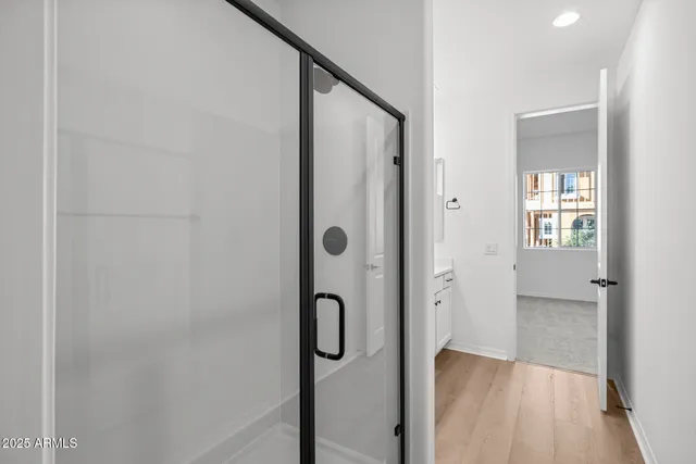 a bathroom with a glass shower door