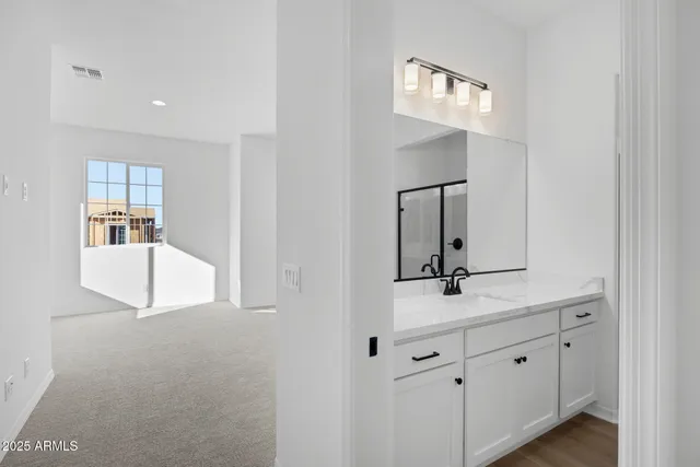 a bathroom with a sink a mirror and window