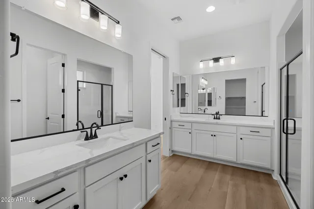 a bathroom with a double vanity sink mirror and