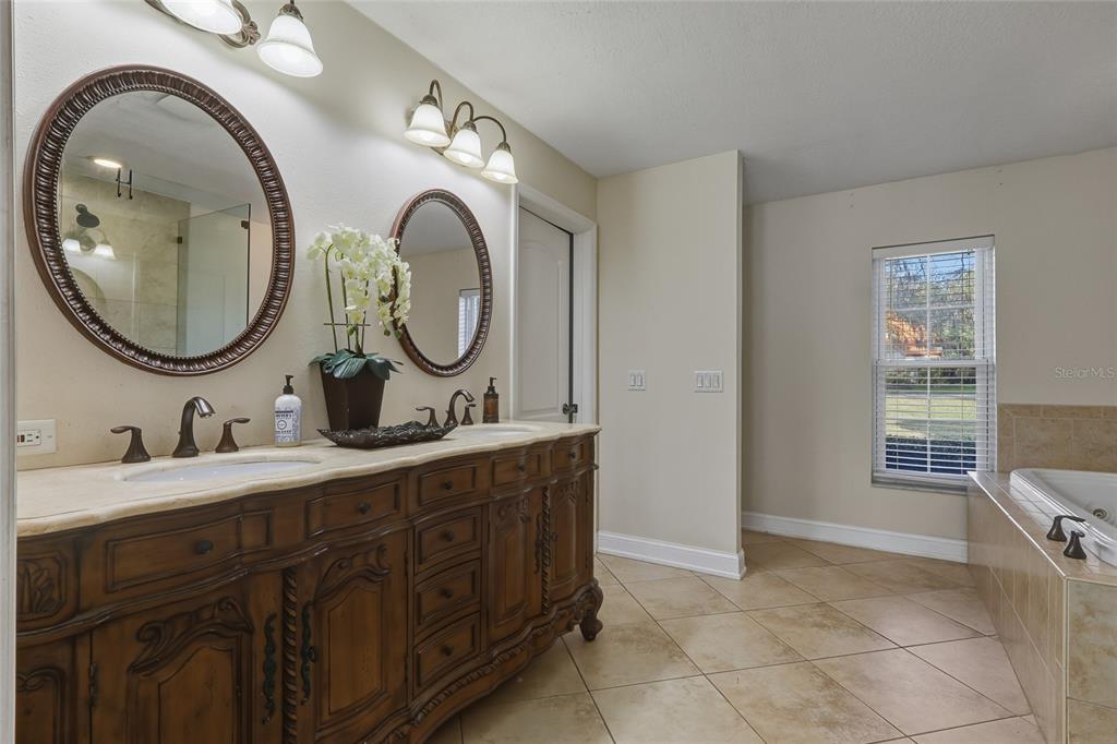 5475 Saddlebrook Way Wesley Chapel, FL 33543 - Photo 12 of 29 a bathroom with a granite countertop double vanity sink and a mirror