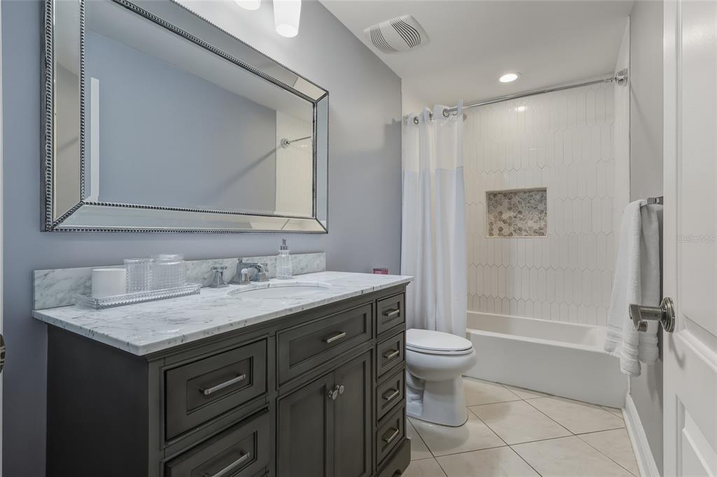 5475 Saddlebrook Way Wesley Chapel, FL 33543 - Photo 14 of 29 a bathroom with a granite countertop sink toilet and shower