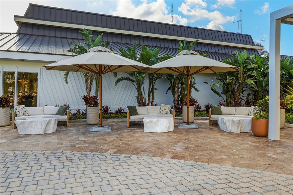 5475 Saddlebrook Way Wesley Chapel, FL 33543 - Photo 21 of 29 a view of a patio with table and chairs under an umbrella