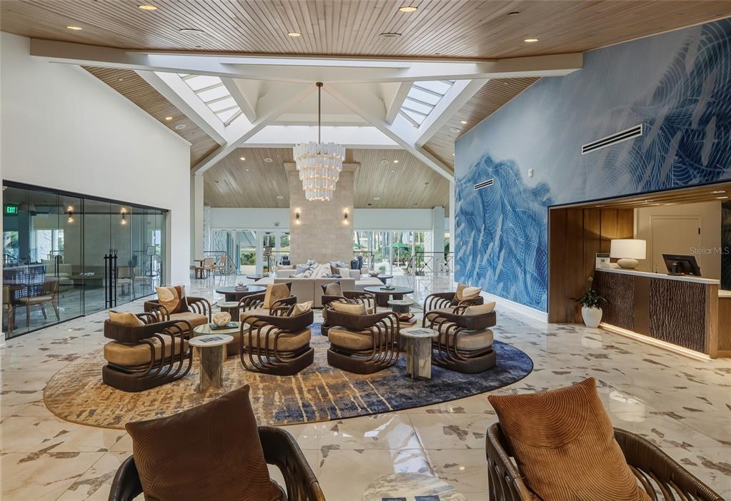 5475 Saddlebrook Way Wesley Chapel, FL 33543 - Photo 24 of 29 a room with lots of chairs and a chandelier