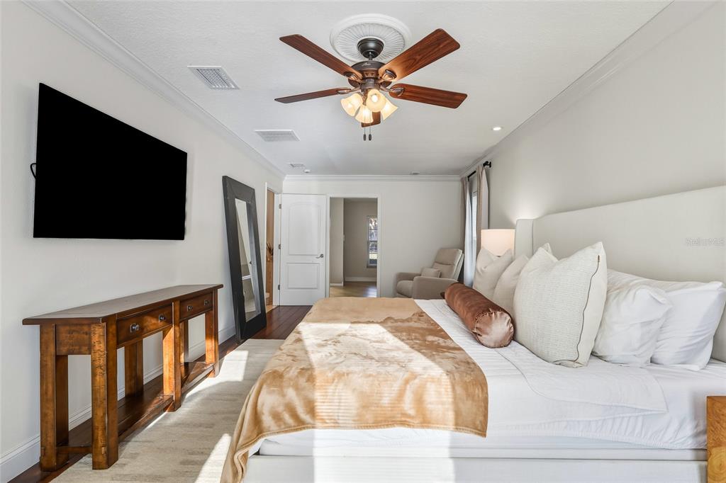 5475 Saddlebrook Way Wesley Chapel, FL 33543 - Photo 10 of 29 a bedroom with a large bed and a flat screen tv