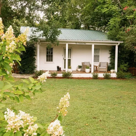 a front view of house with outdoor seating and yard