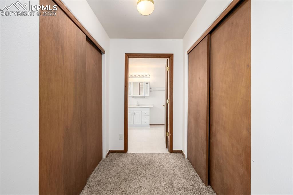 6065 Mulberry Road Calhan, CO 80808 - Photo 16 of 45 Hallway featuring light colored carpet