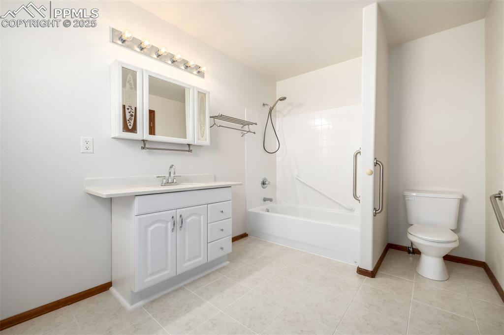 6065 Mulberry Road Calhan, CO 80808 - Photo 17 of 45 Full bath featuring tub / shower combination, vanity, and tile patterned flooring