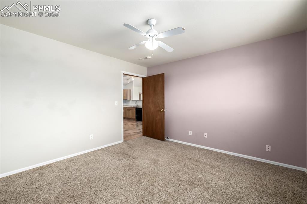6065 Mulberry Road Calhan, CO 80808 - Photo 21 of 45 Unfurnished room with light colored carpet and ceiling fan