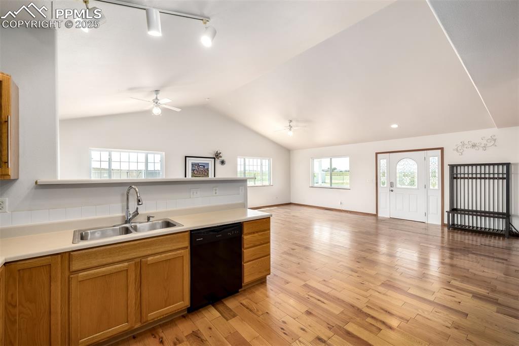 6065 Mulberry Road Calhan, CO 80808 - Photo 9 of 45 Kitchen featuring black dishwasher, a ceiling fan, open floor plan, rail lighting, and vaulted ceiling