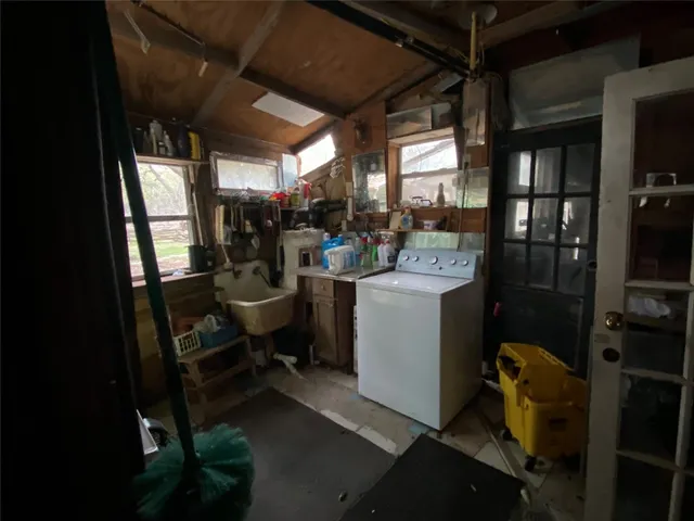a living room with furniture a window and a chandelier