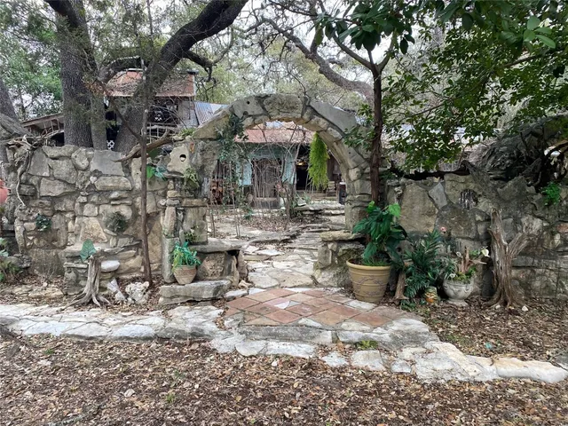 a view of a patio with table and chairs under an umbrella