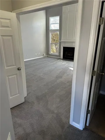 a view of empty room with a fireplace
