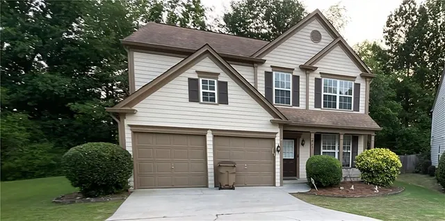 a front view of a house with garden