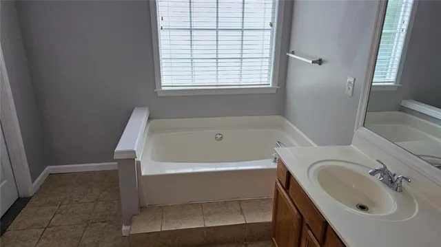 a white bath tub sitting next to a white sink