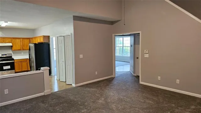 an empty room with closet and a window