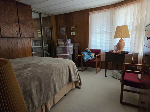 a bed room with a bed and a lamp