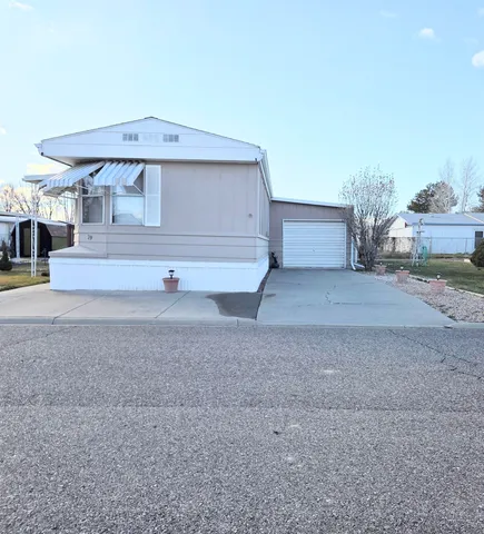 a view of house with backyard and kitchen