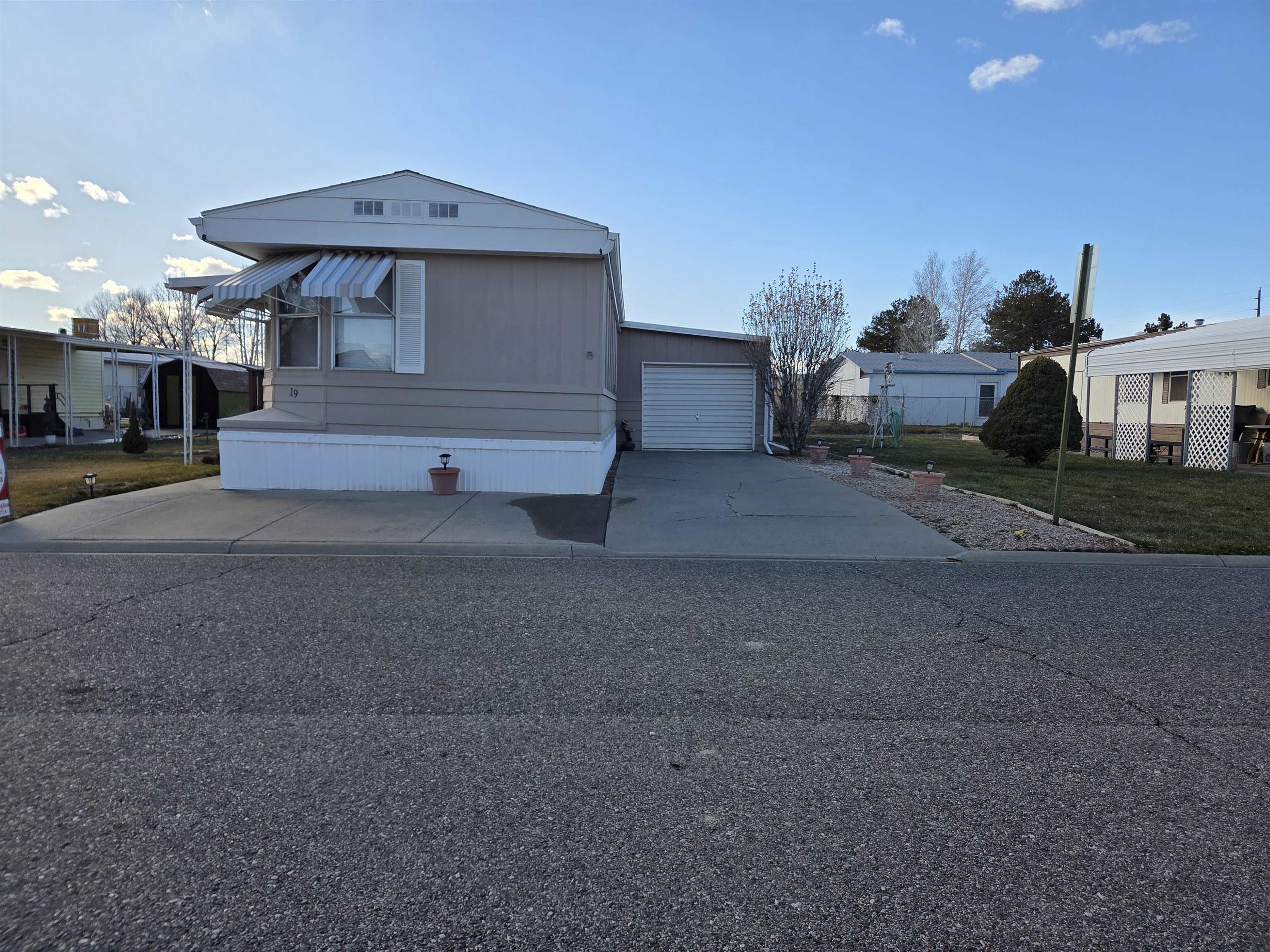 3195 F Road, Unit 19 Grand Junction, CO 81504 - Photo 2 of 20 a front view of a house with garage