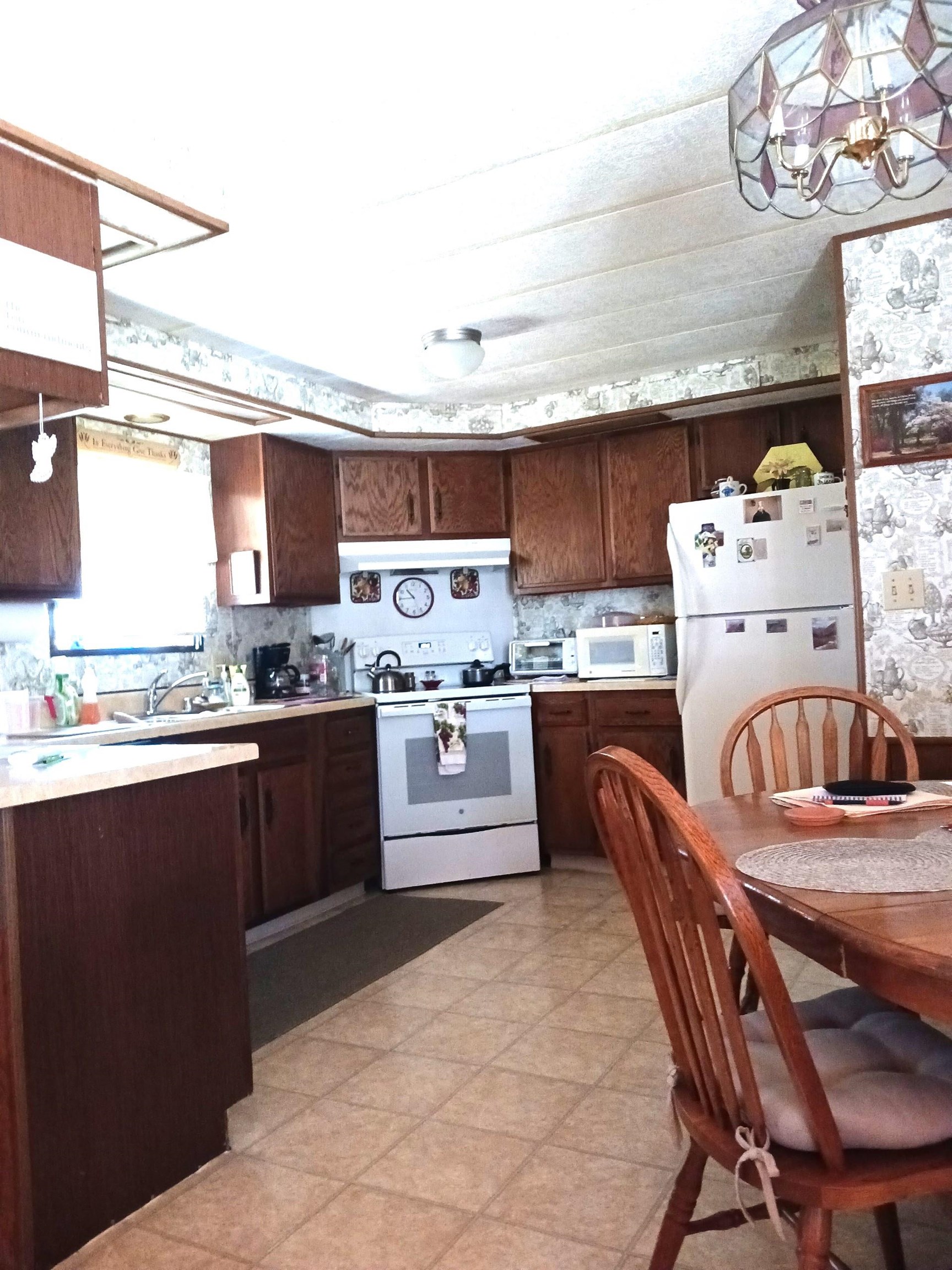 3195 F Road, Unit 19 Grand Junction, CO 81504 - Photo 5 of 20 a kitchen with stainless steel appliances kitchen island granite countertop a sink and cabinets
