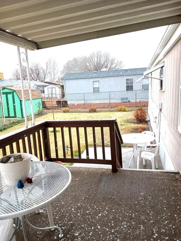 a view of a porch with furniture and a backyard