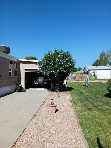 a backyard of a house with table and chairs