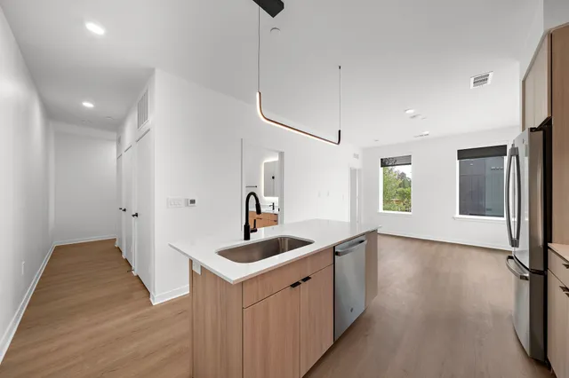 a kitchen with sink and refrigerator