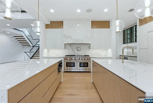 a large kitchen with stainless steel appliances granite countertop a sink and a stove