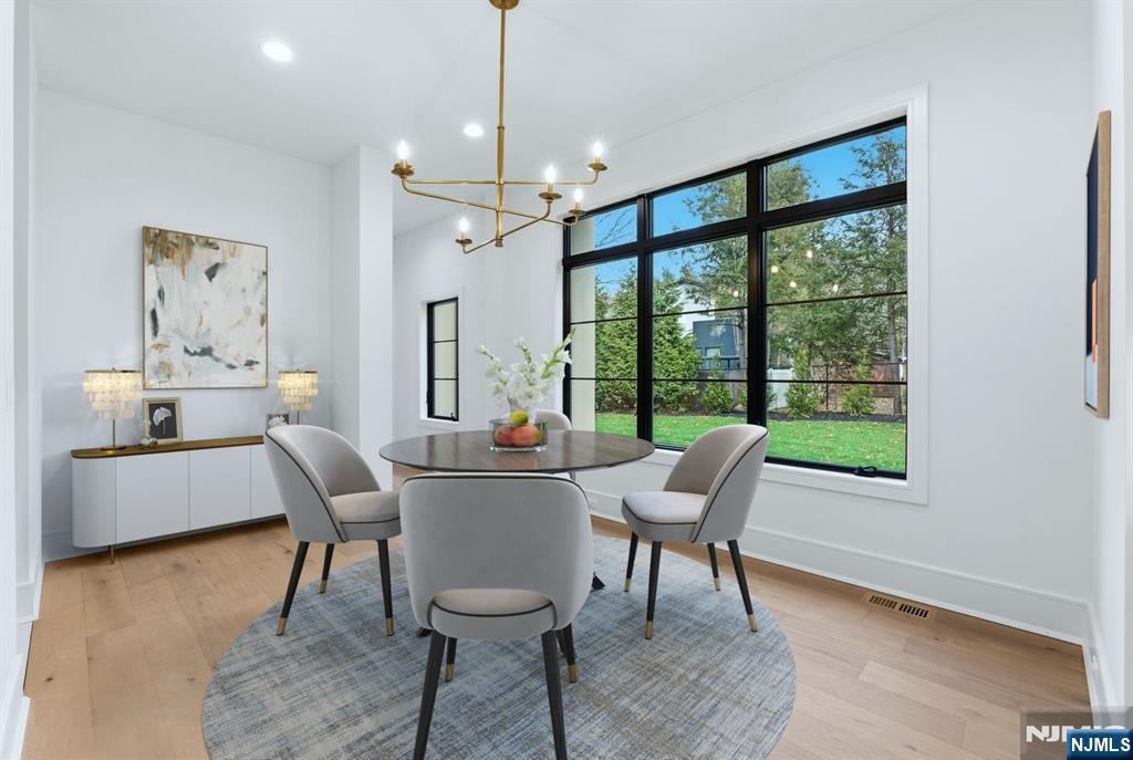 12 Irene Court Demarest, NJ 07627 - Photo 16 of 49 a living room with furniture a window and a chandelier